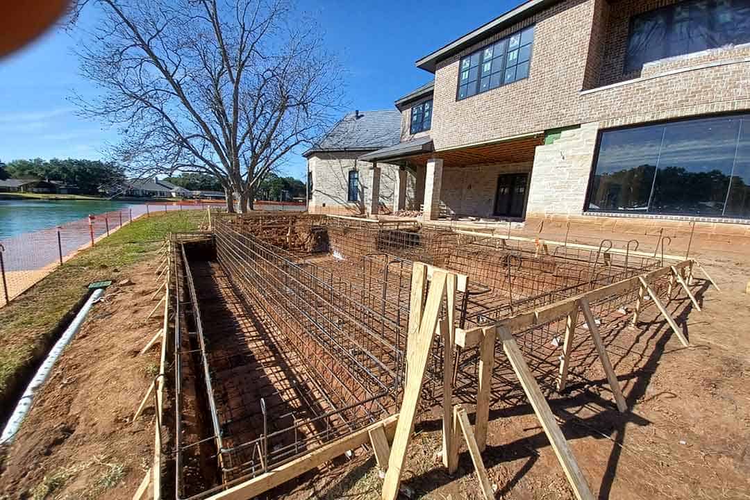 Excavation and steel reinforcement for in-ground swimming pool construction by Downunda Pools in backyard. Skilled pool builders creating custom pools in Houston with quality craftsmanship.